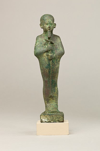Late Period bronze Ptah, mummiform and skullcapped, gripping the sceptre; a typical votive figure of the god, 664–30 BCE.
