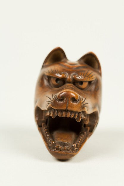 19th-century Japanese netsuke carved as a Kyōgen kitsune mask, with open jaws, fangs and pointed ears.