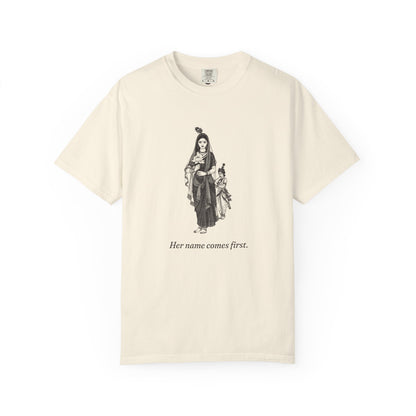 Radha · “Her name comes first.” — Garment-Dyed One-Ink Tee