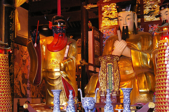 Gilded City God statue flanked by an attendant figure with red face, Shanghai City God Temple, 2009.