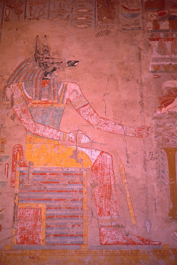 Painted relief of enthroned, jackal-headed Anubis in his chapel at Hatshepsut's mortuary temple.