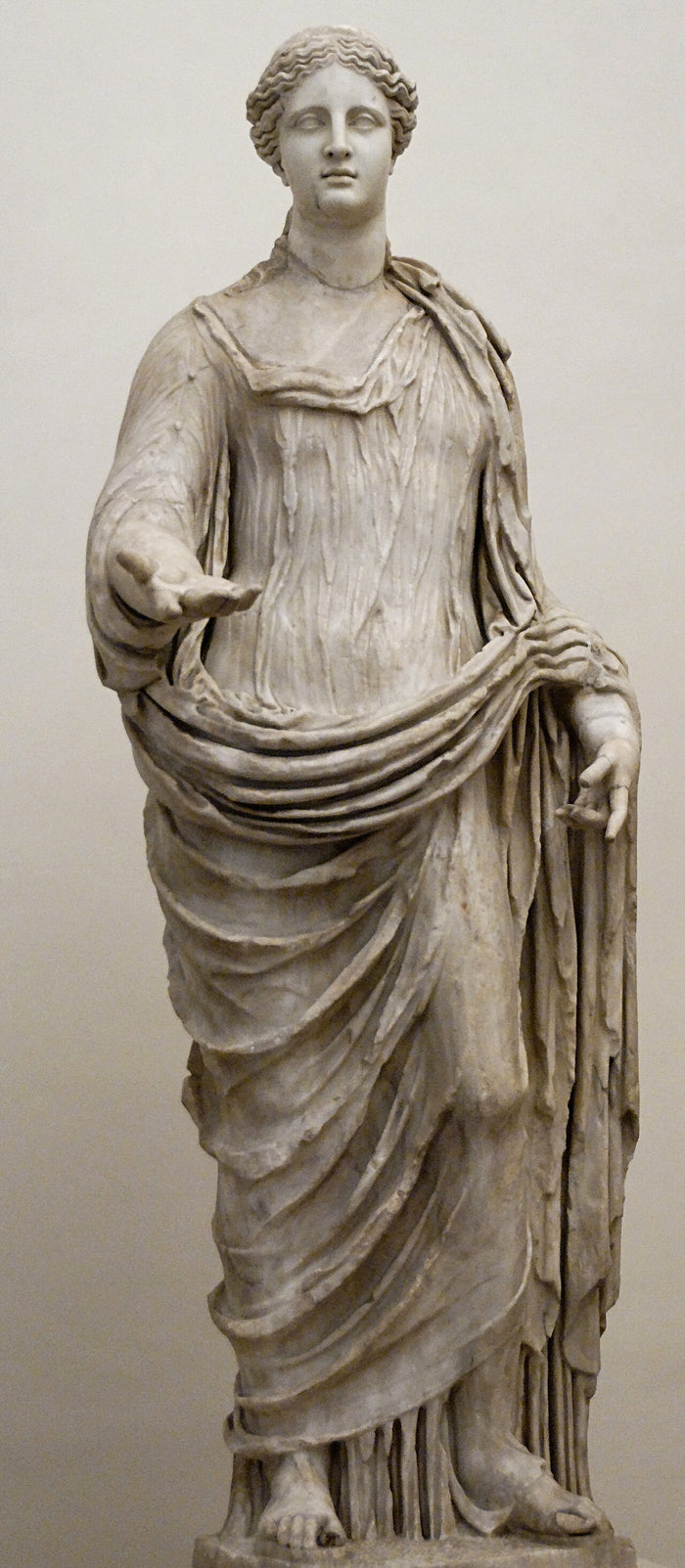 Draped marble statue of Demeter (Altemps collection), her outstretched hand in a giving gesture.
