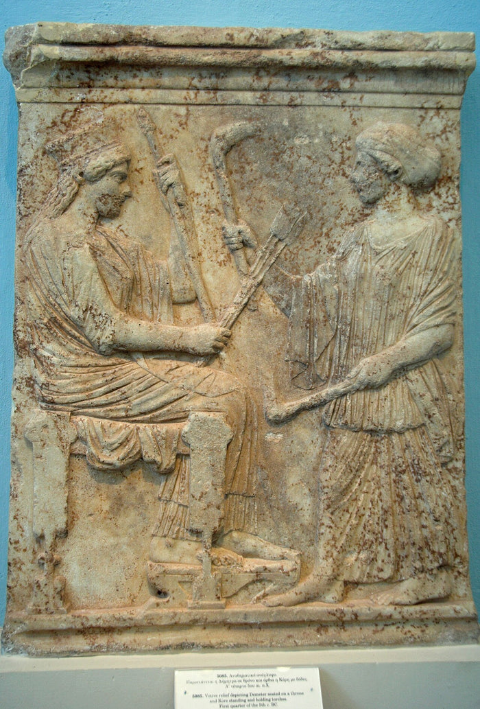 Marble votive relief from Eleusis, 500–475 BC: Demeter enthroned with Kore standing, both holding torches.