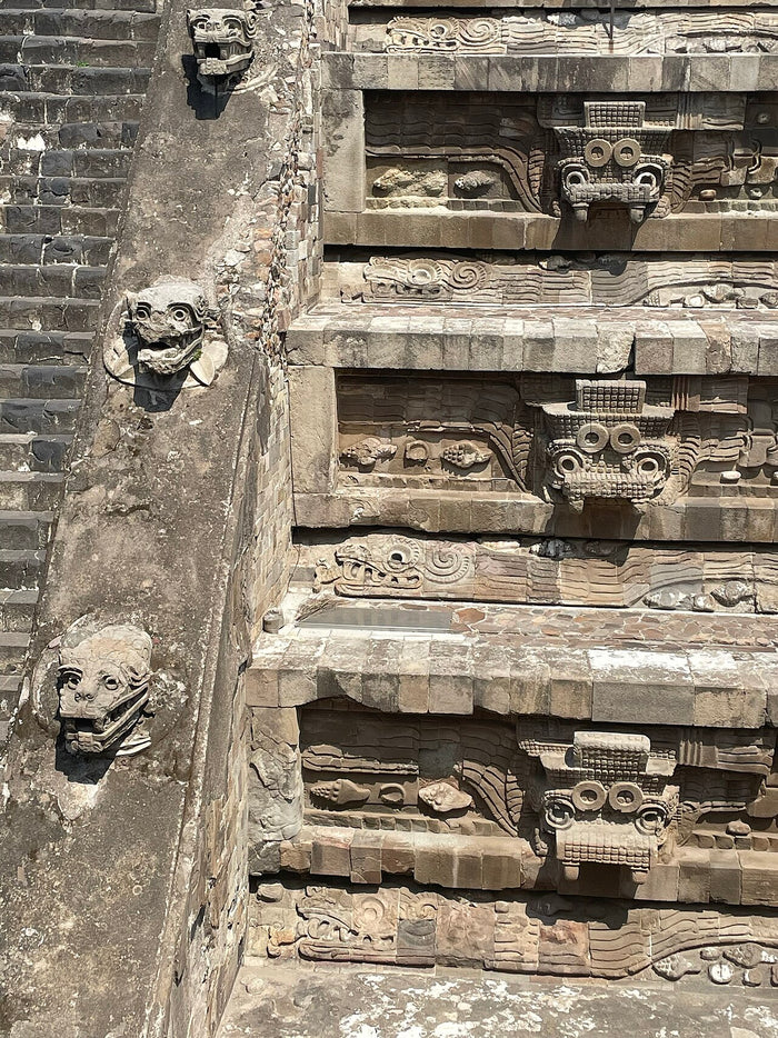 Tlaloc heads and symbols on the stairs of the Temple of the Feathered Serpent, Teotihuacan, showing the god's early importance.