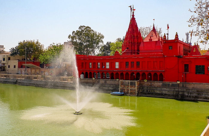 Durga Mandir and its kund (tank), a red temple dedicated to Durga, photographed in 2019.