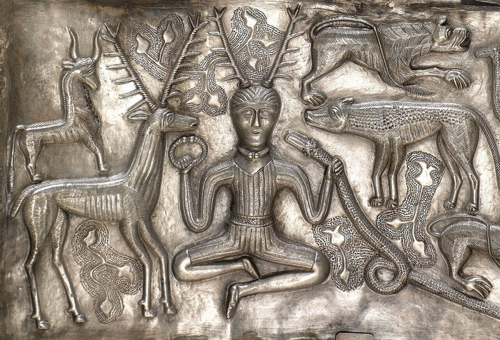 Gundestrup Cauldron plate showing the antlered, cross-legged figure with torc and serpent, surrounded by stags and animals, the best-known Cernunnos image.