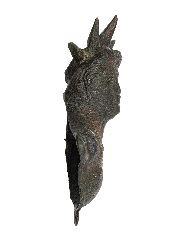 Bronze head of Helios in profile, with the spiky solar rays that mark him as sun god.