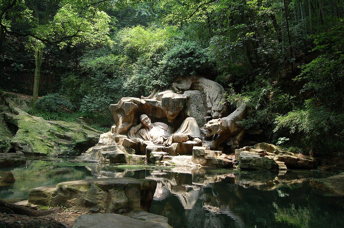 Hupao spring in Hangzhou, where a sculpture shows the reclining monk, linked to Ji Gong's legend.