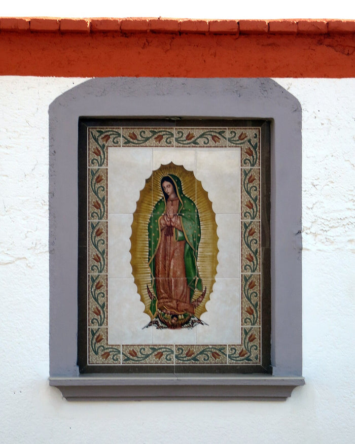 Tile panel of Our Lady of Guadalupe with golden rays and green mantle, a common form of popular devotion in Mexico.