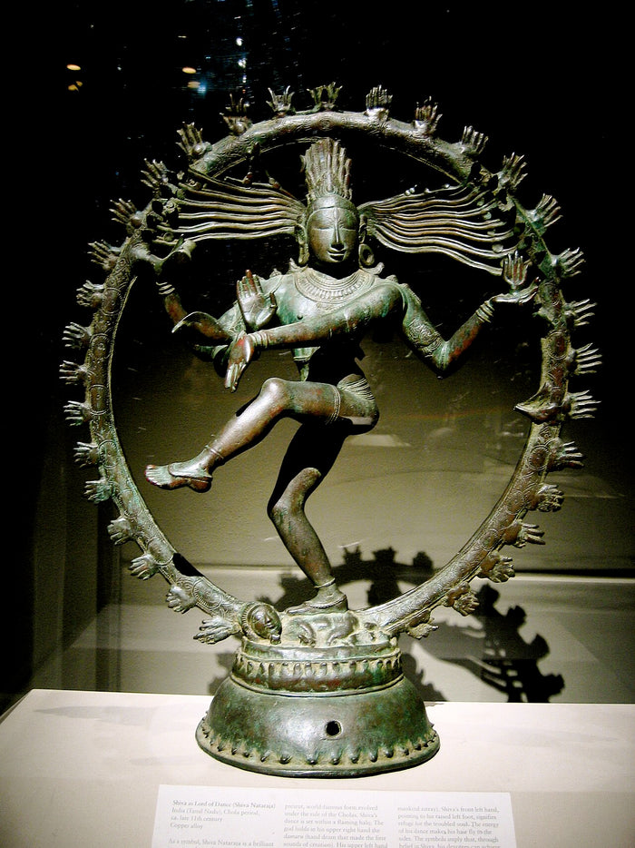 Chola-style bronze Nataraja dancing within a ring of flames, with the drum, flowing locks and raised foot.