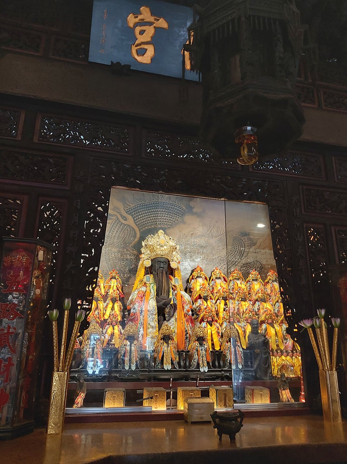 Altar of a Taiwanese temple to the martial god of wealth, with a black-faced central deity and attendants.