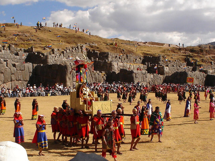Inti Raymi reenactment at Sacsayhuamán: the Sapa Inca is carried on a litter before the stone walls, honoring the sun god.