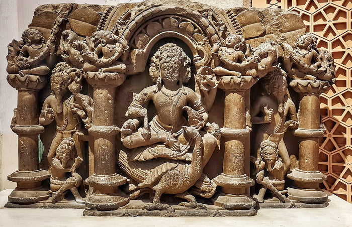Eighth-century Kartikeya relief from Abhaneri, seated with his peacock, showing early North Indian Skanda worship.