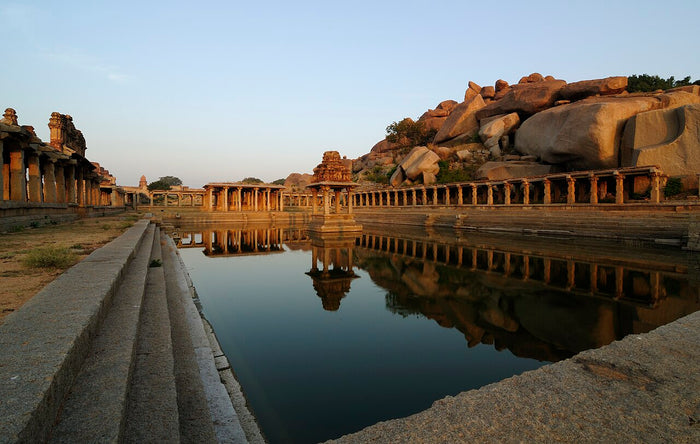 Sacred tank and pillared mandapas at the Krishna Temple complex in Hampi, a Vijayanagara-era site devoted to Krishna.