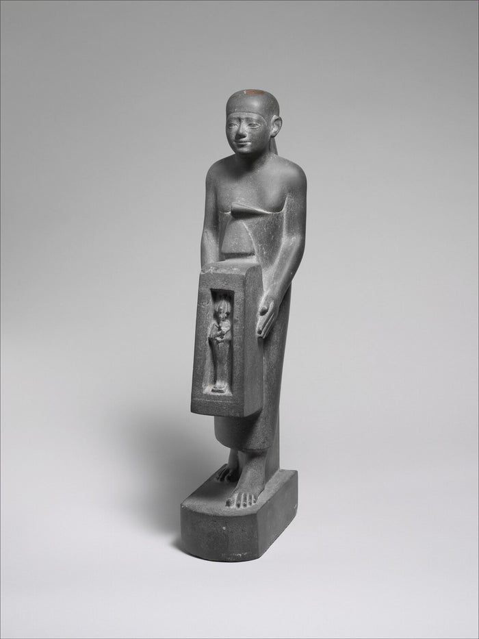 Late Period statue (5th–4th century BC) of a man holding a shrine containing an image of Osiris.