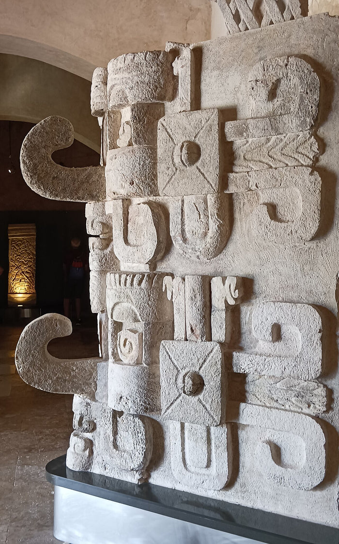 Puuc-style Chaac masks with stacked elements and curling snout, displayed at the Museo de Arquitectura Maya, Campeche.