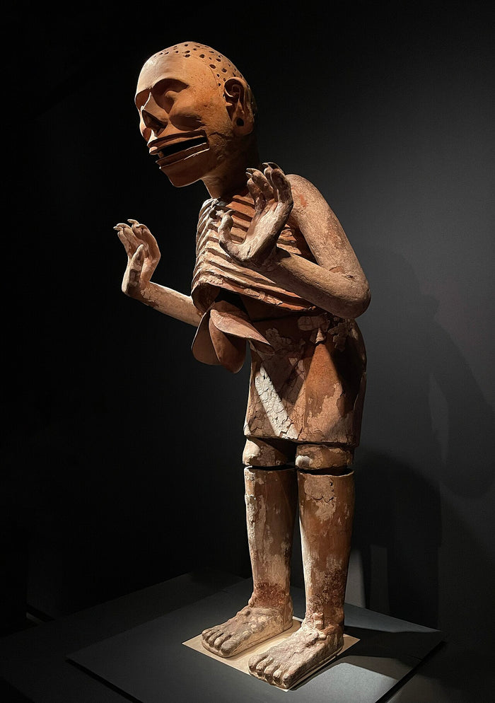 Three-quarter view of the Templo Mayor Mictlantecuhtli, showing the perforated scalp, open jaw and ribcage that mark the death god.