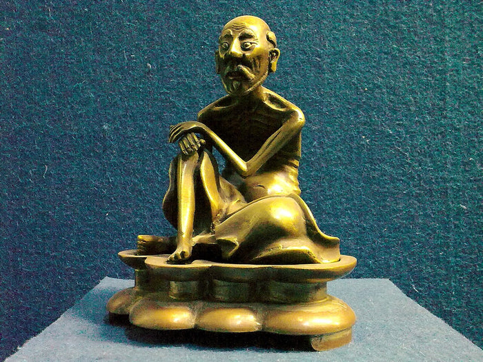 Mongolian bronze of Milarepa, emaciated from ascetic practice, seated with his arm resting on a raised knee.