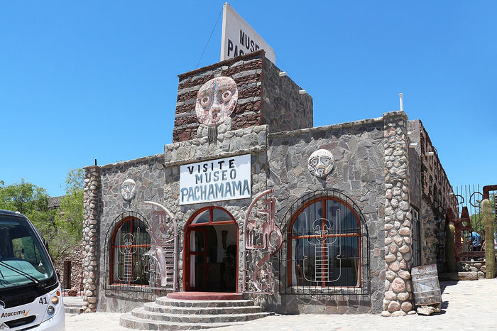 Museo Pachamama, 2018: stone-built museum with carved masks at its entrance, a site devoted to Andean Mother Earth.