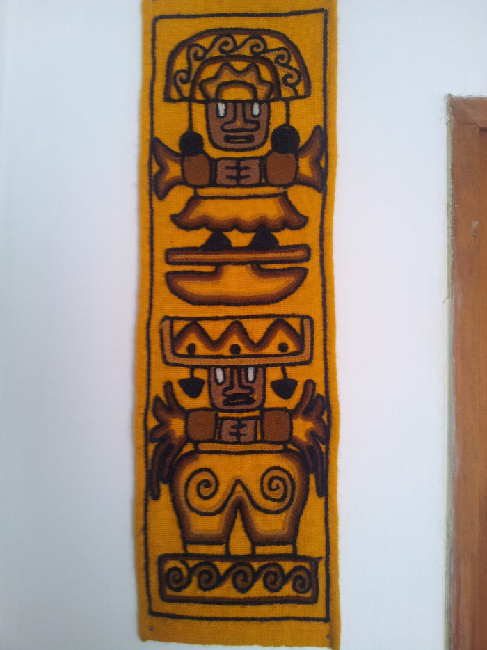 Woven wool wall hanging titled "Pachamama & pachapapa", showing paired Andean figures in stylised iconography of the earth deity and a male counterpart.
