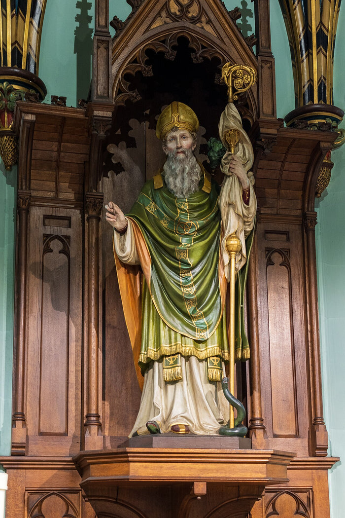 Portsmouth Cathedral statue of Patrick in green vestments with crozier and a serpent at his feet, recalling the banishing of snakes.