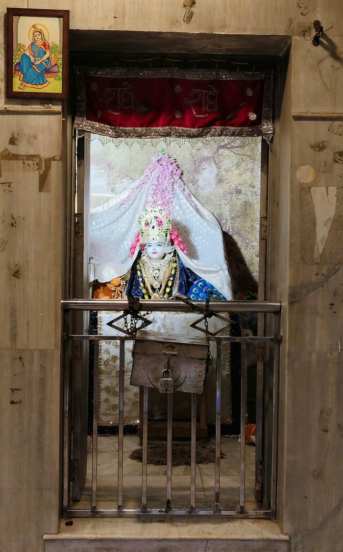 Radha Rani deity image in a shrine at Rawal Temple, crowned and richly dressed, as worshipped by devotees.
