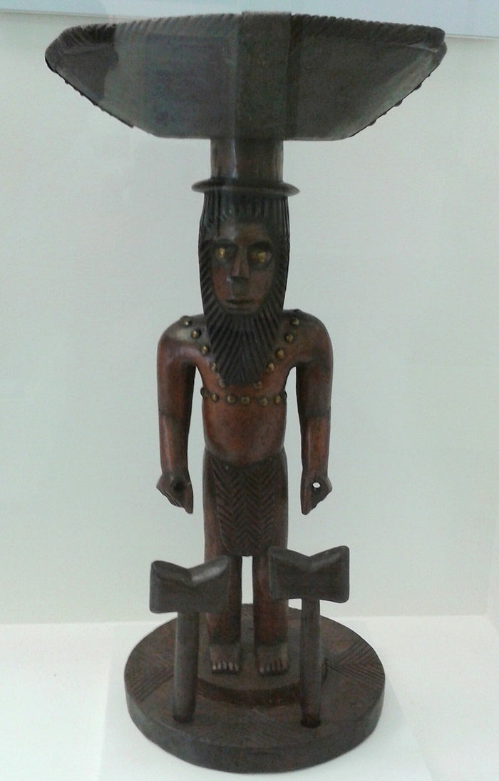 Carved representation of Xangô, shown bearded and holding twin double axes, as he is honoured in Brazilian Candomblé.