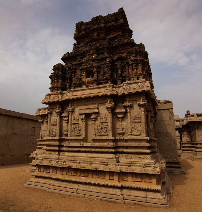 Stone Saraswati temple with richly carved tiers, showing the goddess's place in Indian temple architecture.
