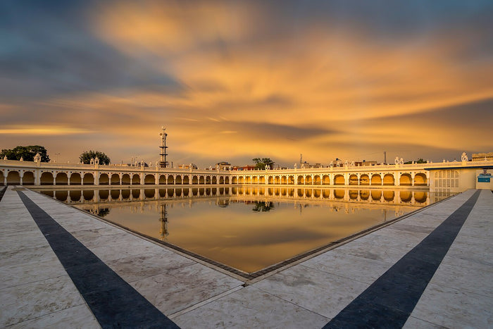 Sarovar (sacred pool) at Gurdwara Janam Asthan, Nankana Sahib, glowing at sunset, 2016.