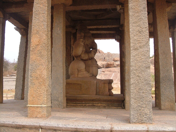 Monolithic Ganesha statue within a pillared stone pavilion at Hampi, a Vijayanagara-era site devoted to him.