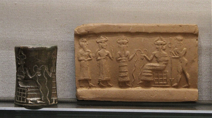 Akkadian-period cylinder seal and impression of Enki enthroned with attendants, in the Agade style; the god wears a horned crown.