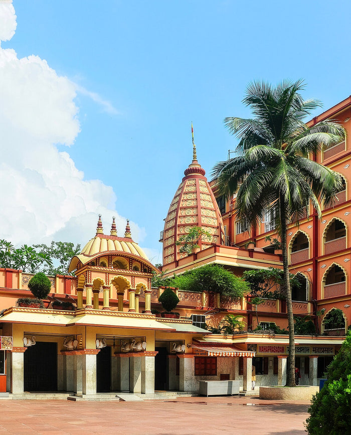 ISKCON temple with its shikhara and palm-fronted courtyard, representing Gaudiya Vaishnava worship of Krishna.