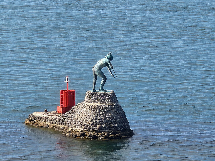 Bronze statue of Tangaroa on a stone plinth at Mount Maunganui, honouring the Māori god of the sea.