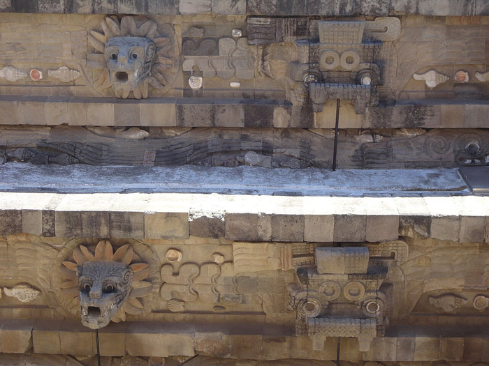 Temple of Quetzalcoatl (Feathered Serpent Pyramid) at Teotihuacan, with serpent heads and feathered-serpent reliefs on the facade.