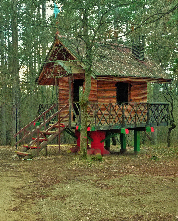 Hut on stilts imitating Baba Yaga's house on chicken legs, built in a forest.