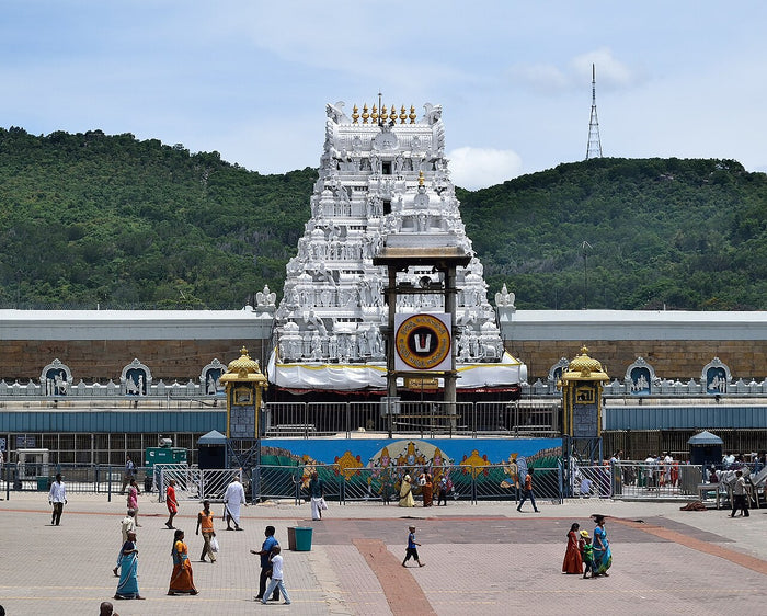 Entrance gopuram of the Tirumala Venkateswara temple, the principal shrine of the deity, seen from the forecourt with the hills behind.