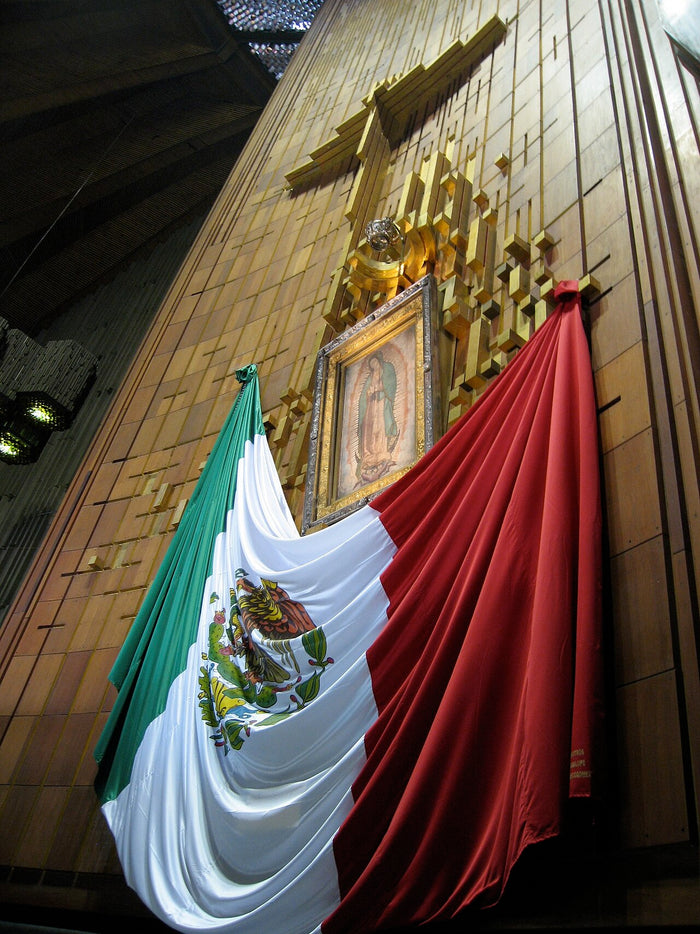 The venerated image displayed in the Basilica of Our Lady of Guadalupe, Mexico City, draped with the Mexican flag.