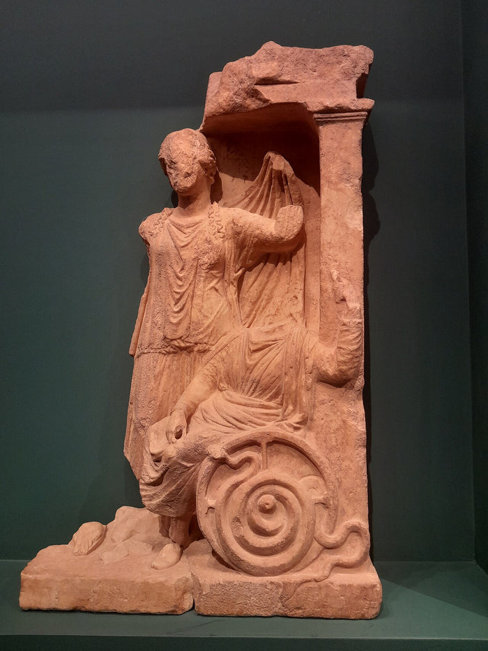 Votive relief from Eleusis showing Demeter with Triptolemus on his serpent-drawn chariot, a link to her grain gift.