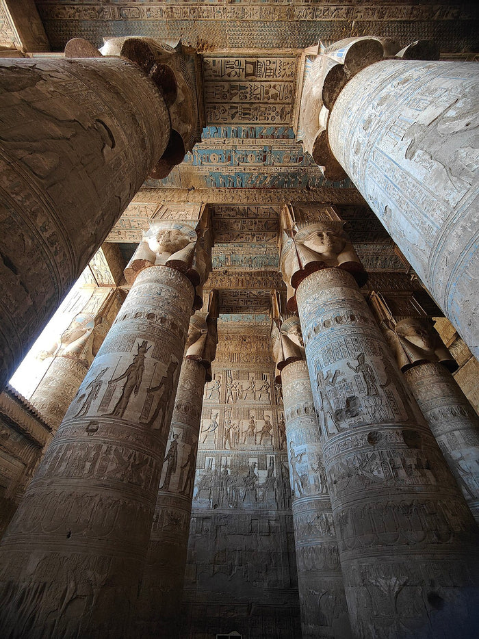 Hathor-headed column capitals in the Dendera temple hall, the major cult center devoted to Hathor.