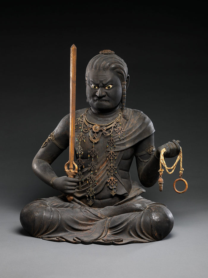 Early 13th-century wooden seated Fudō Myōō with fierce expression, sword and coiled rope, adorned with jeweled ornaments.