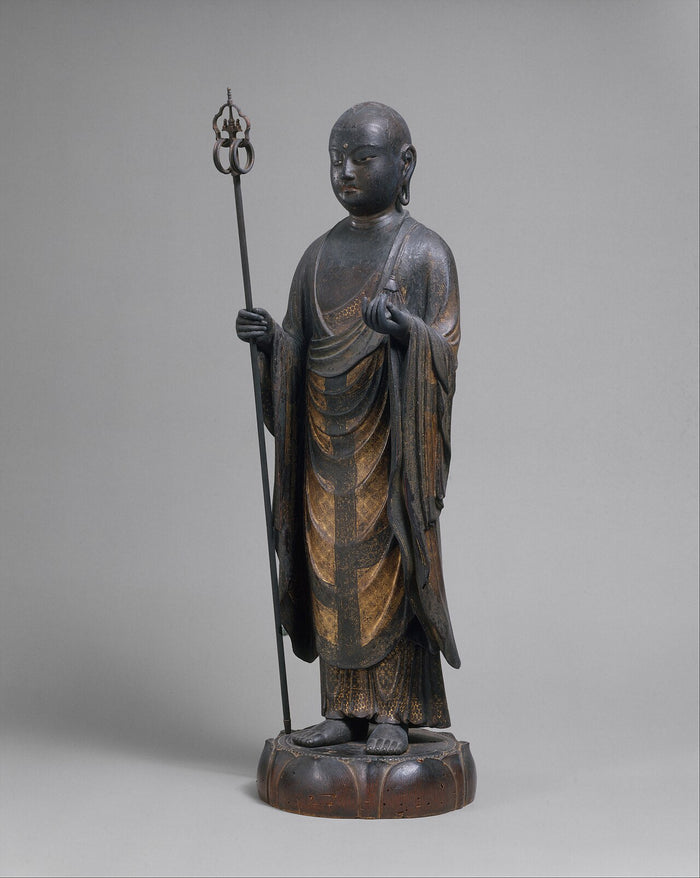 Wooden Jizō statue, circa 1202: standing monk with staff and jewel, traces of gold-patterned robes on a lotus base.