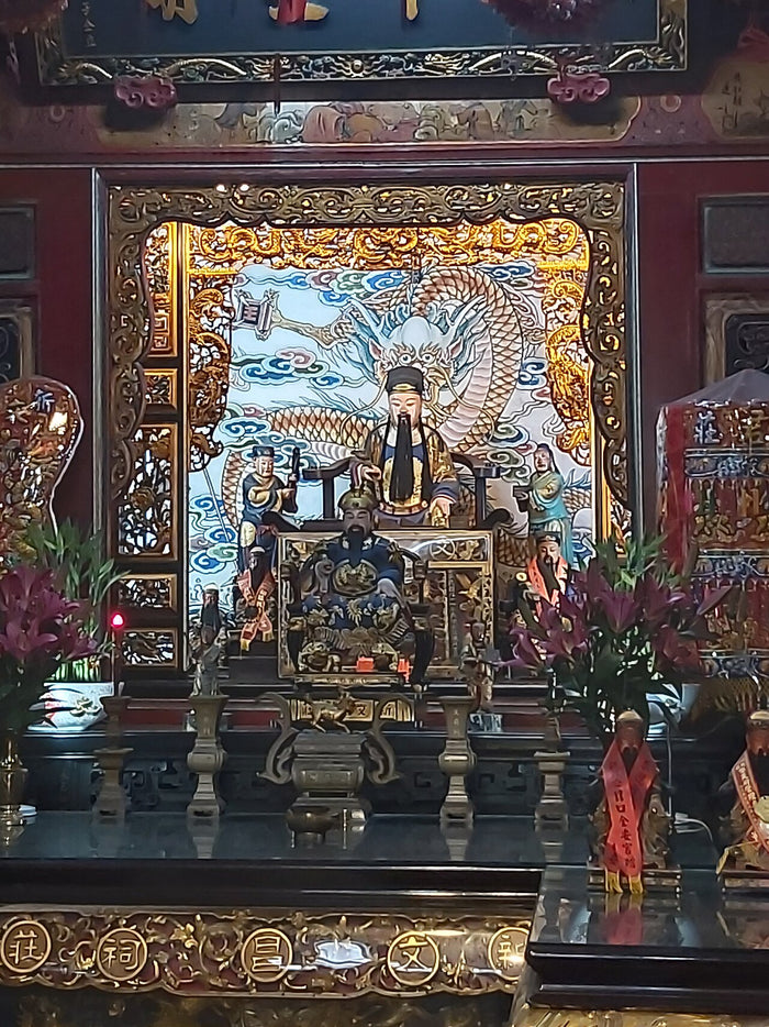 Wenchang Dijun enthroned at Xinzhuang Wenchang Temple, flanked by attendants before a dragon backdrop (2025).