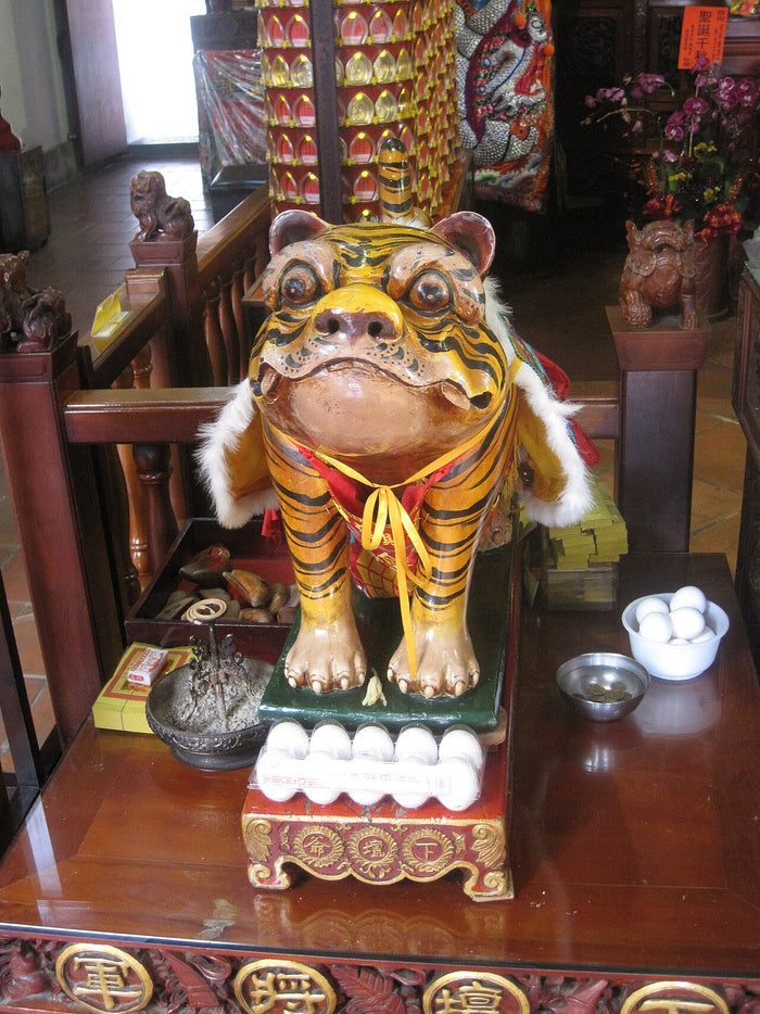 Hu Ye figure in tiger-striped cape with eggs, a typical offering, at Sidian Xingji Temple.