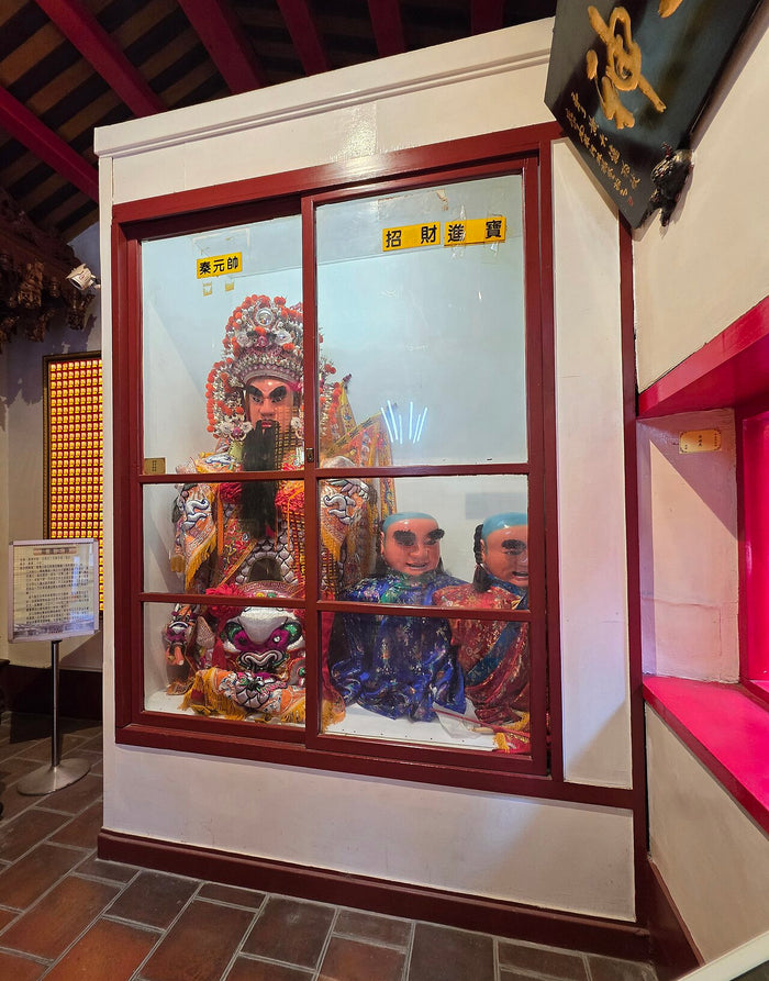 Shrine at Fengyuan Ciji Temple, Taiwan, with Marshal Qin and the masked Zhaocai and Jinbao boy deities, labelled in yellow signs.
