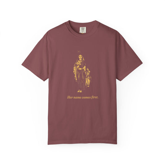 Radha · “Her name comes first.” — Garment-Dyed One-Ink Tee