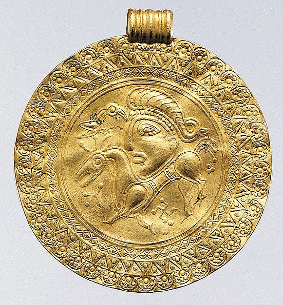 Scandinavian gold bracteate, 400–600, showing a human head with a bird; this imagery is often linked to Odin.