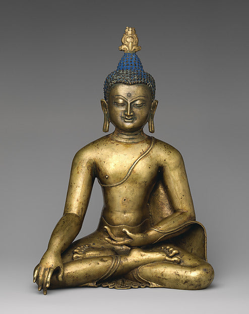 Gilt bronze Buddha Shakyamuni, 12th century Central Tibet, seated in earth-touching gesture, with blue hair and a cranial protuberance.
