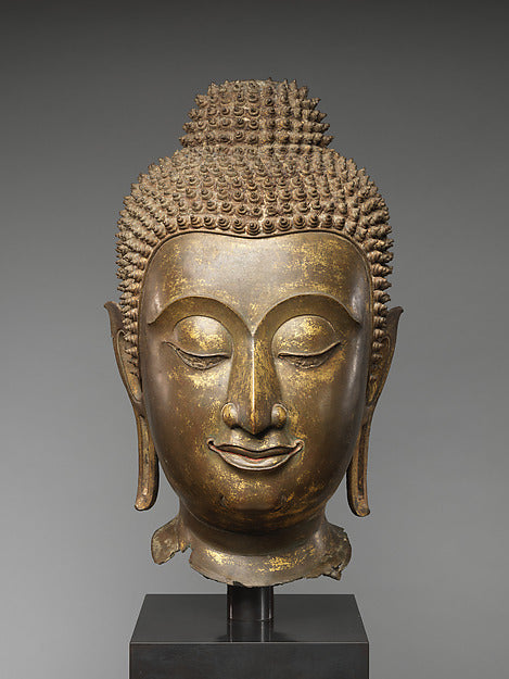 Bronze head of Buddha Shakyamuni, 15th–16th century Thailand, with tight curls, elongated earlobes and serene half-closed eyes.