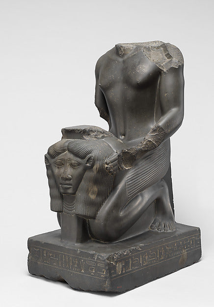 Kneeling statue of Amenopetemhat holding the Hathor emblem, 664–610 BCE, showing devotion to her cult.