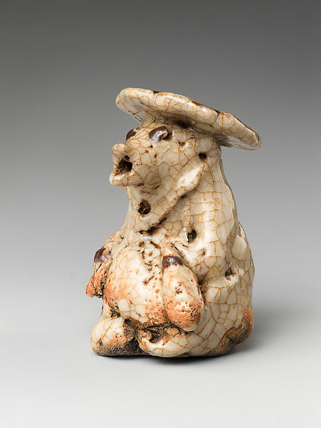 Early 17th-century ceramic water-dropper shaped like a raccoon dog wearing a hat, an early tanuki depiction.